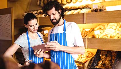 Two people working at a bakery